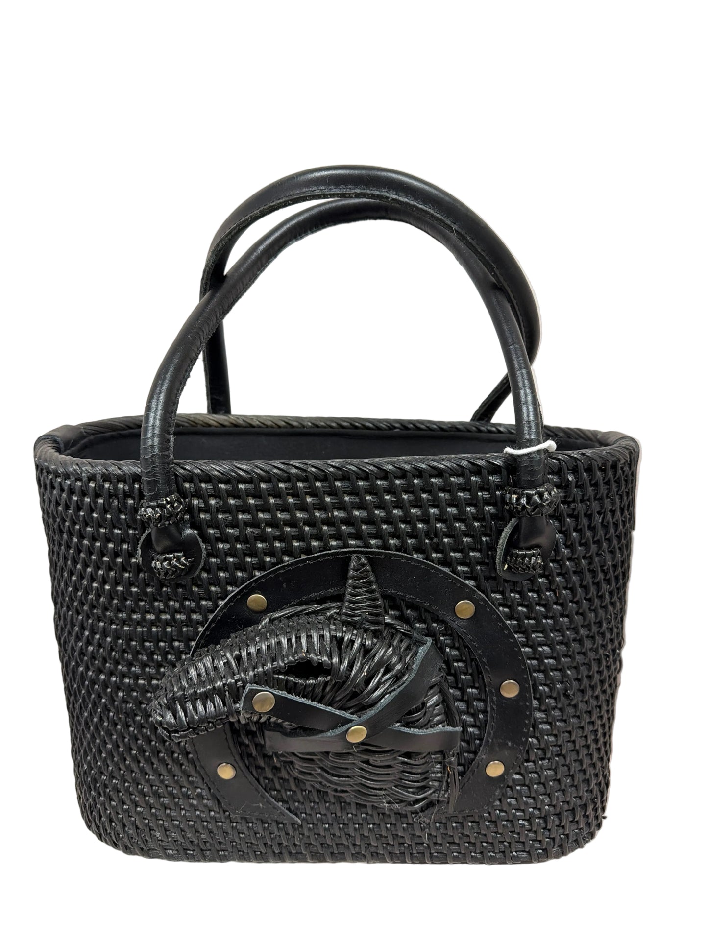 Black woven handbag with a decorative emblem on a light background