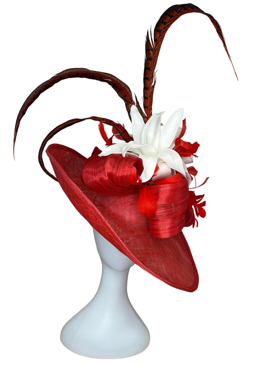 Red decorative hat with white flowers on a mannequin head against a neutral background