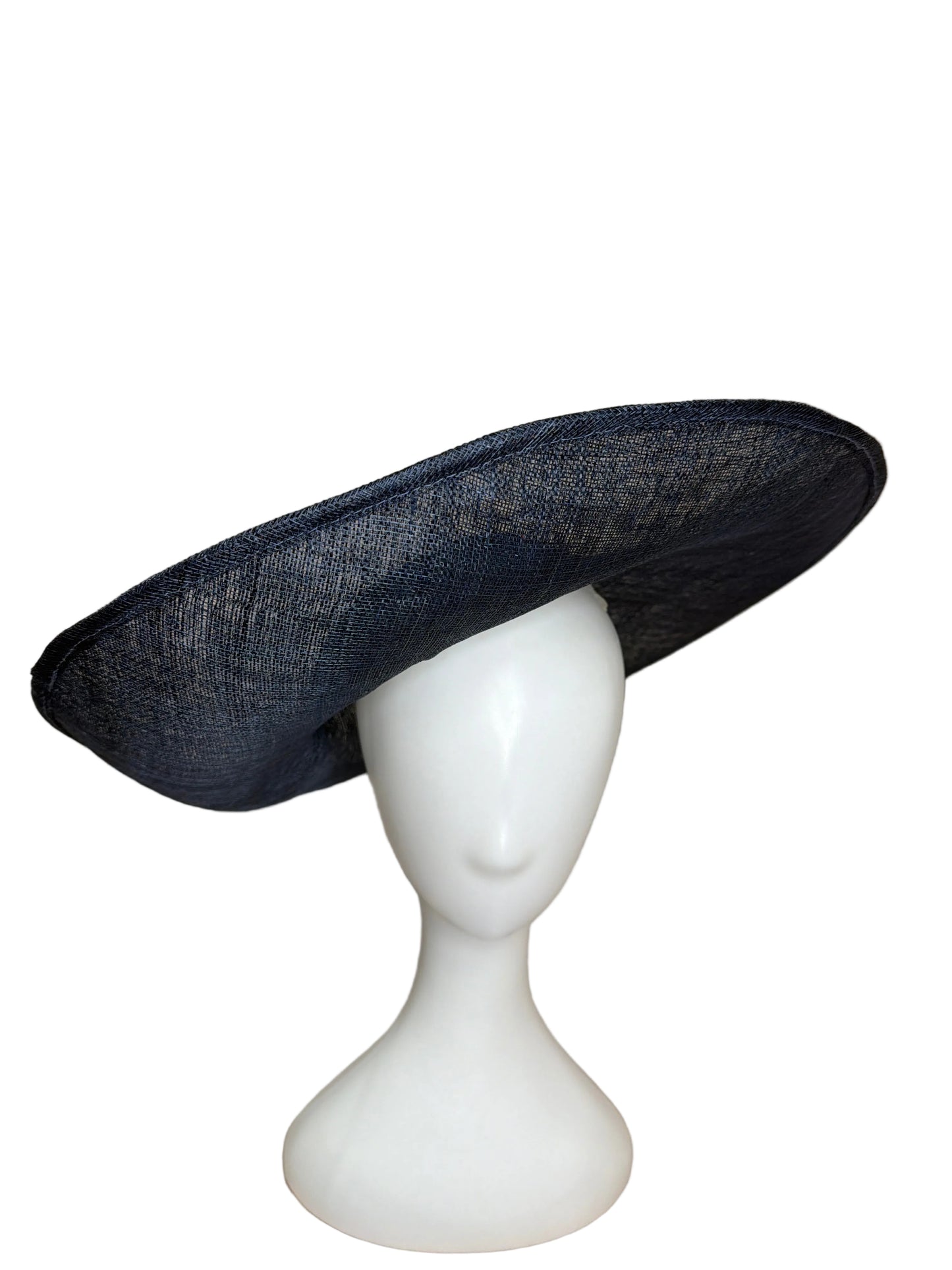 Black hat on a white mannequin head against a beige background