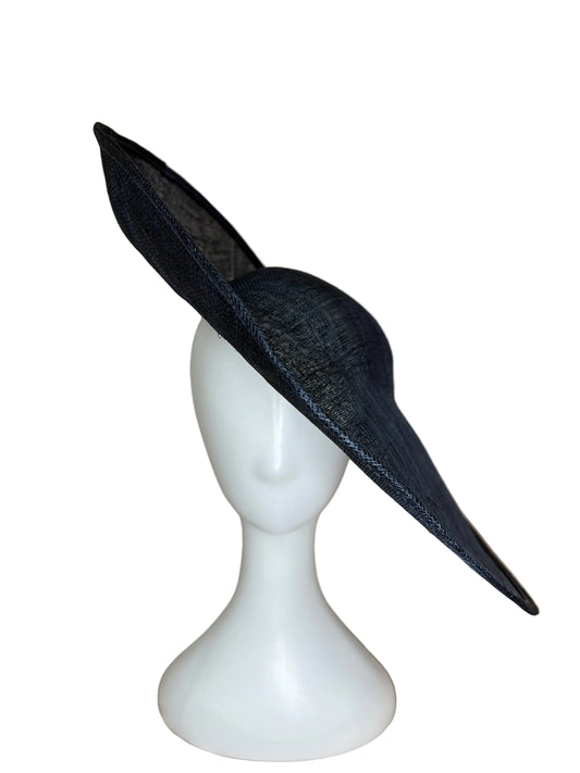 Navy wide-brimmed hat on a white mannequin head against a beige background