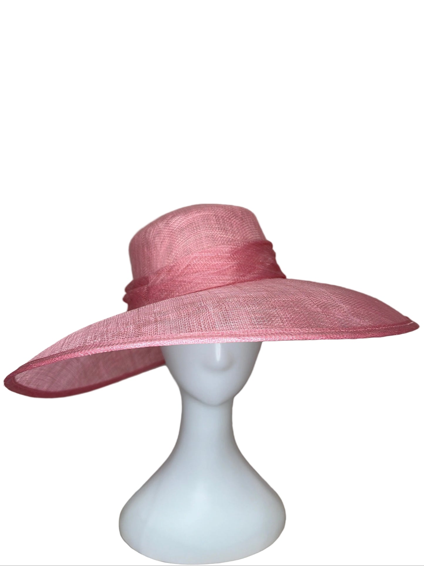 Pink wide-brimmed hat on a mannequin head against a beige background