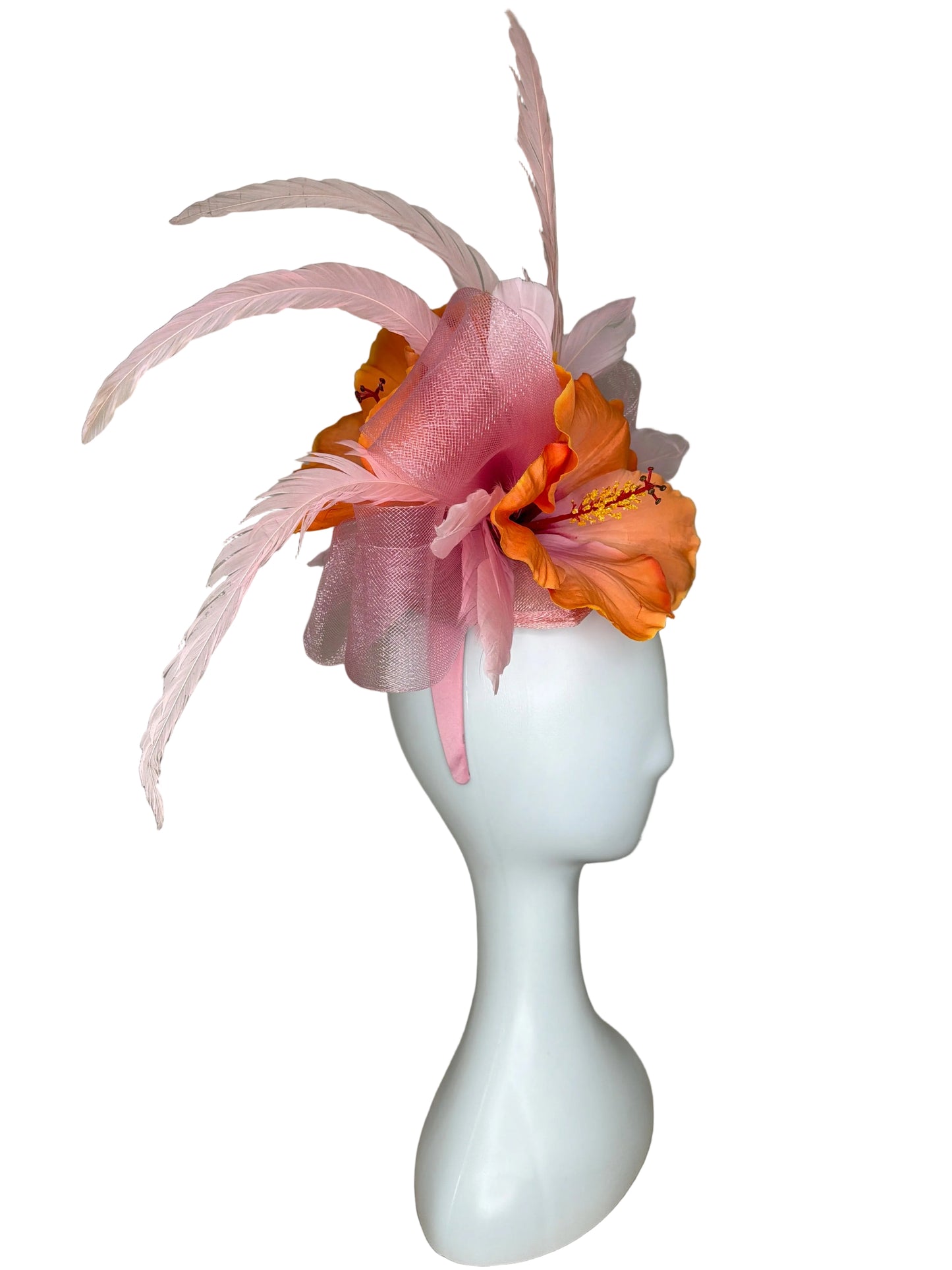 Decorative headband with flowers and feathers on a mannequin head against a beige background