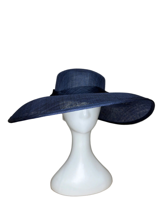 Navy blue wide-brimmed hat on a white mannequin head against a beige background