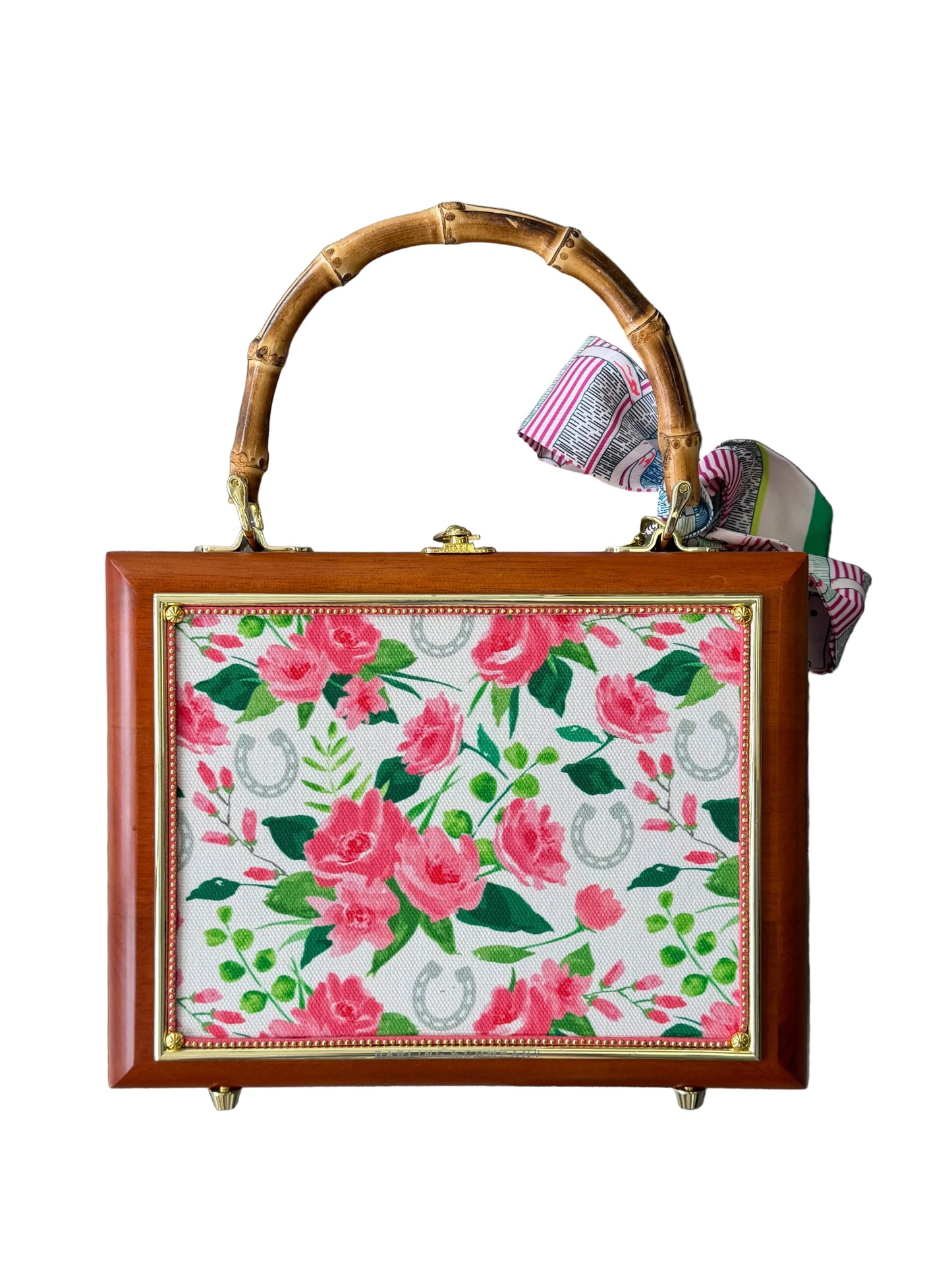 Floral-patterned box with bamboo handle on a wooden surface