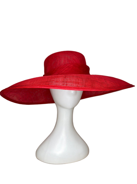 Red hat on a white mannequin head against a beige background