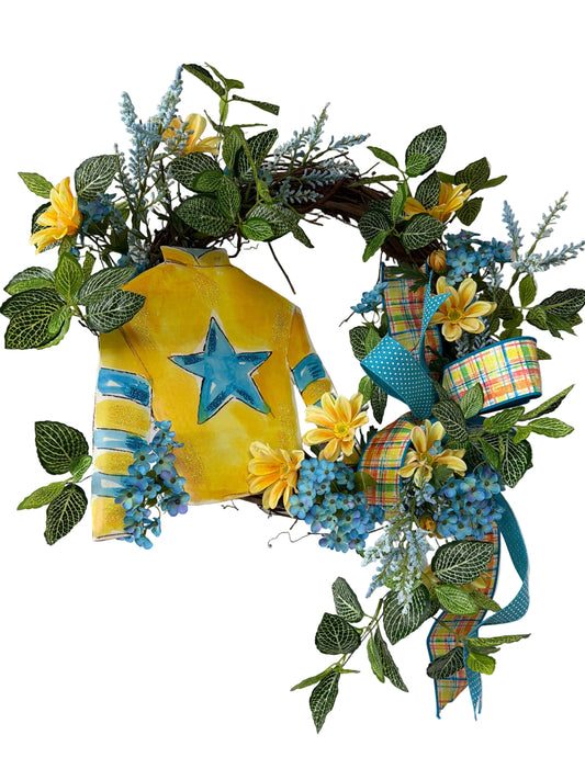 Decorative wreath with yellow center, blue star, and greenery on a white background