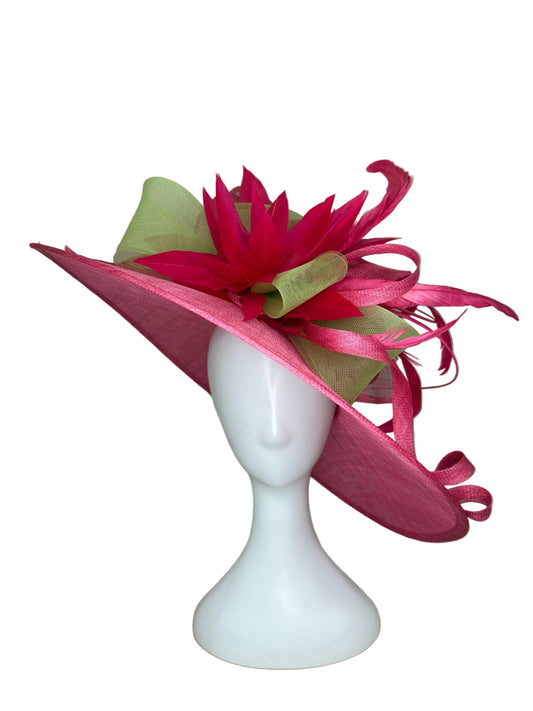Pink feathered hair accessory on a mannequin head against a beige background