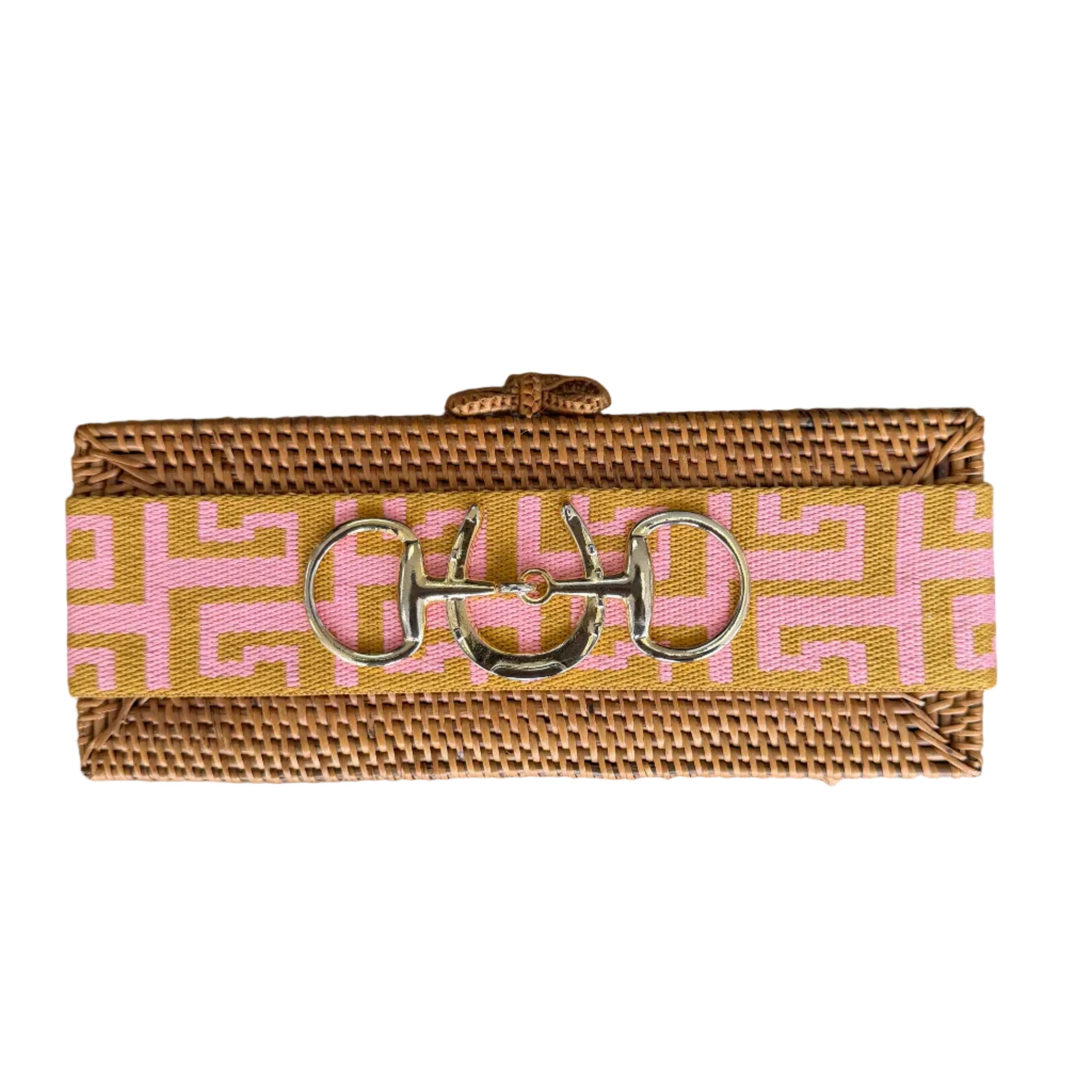 Woven key fob with pink and gold pattern on a wooden surface