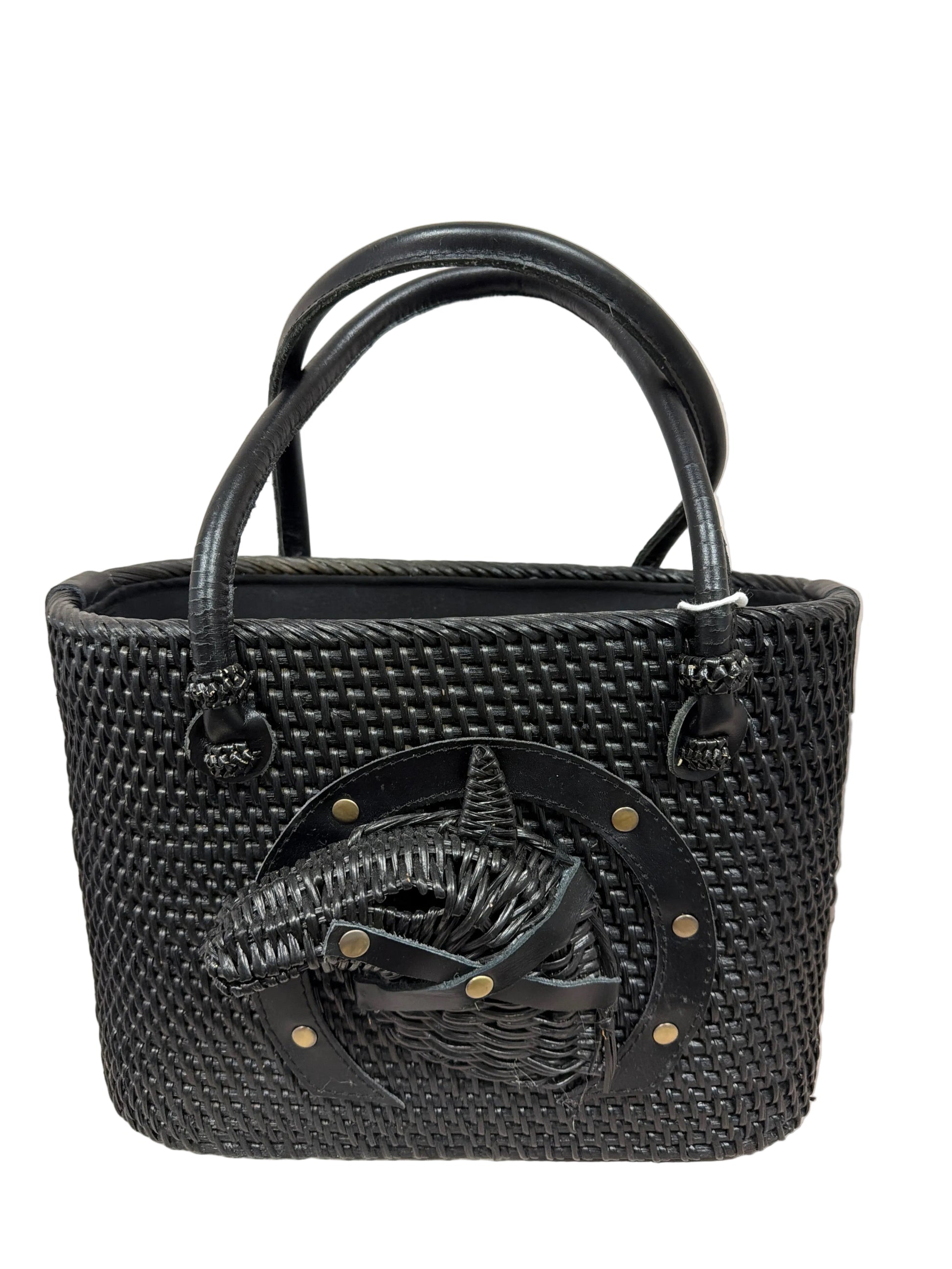 Black woven handbag with a decorative emblem on a light background