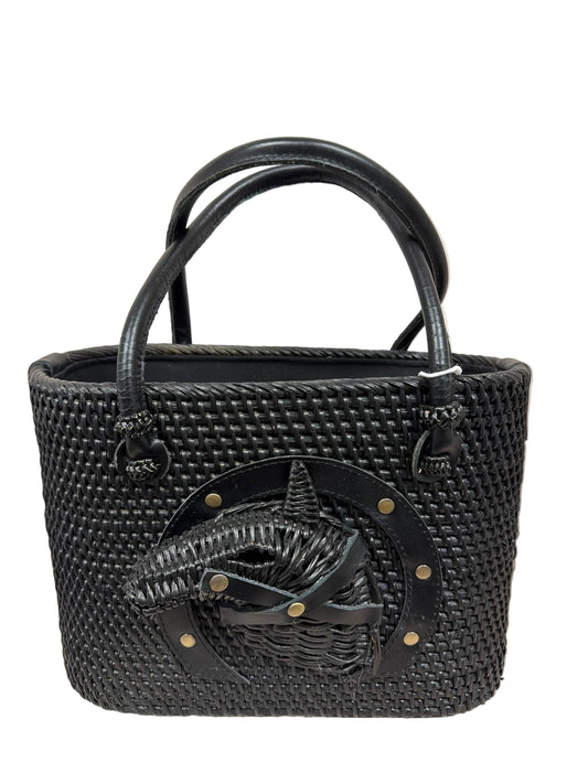 Black woven handbag with a decorative emblem on a light background