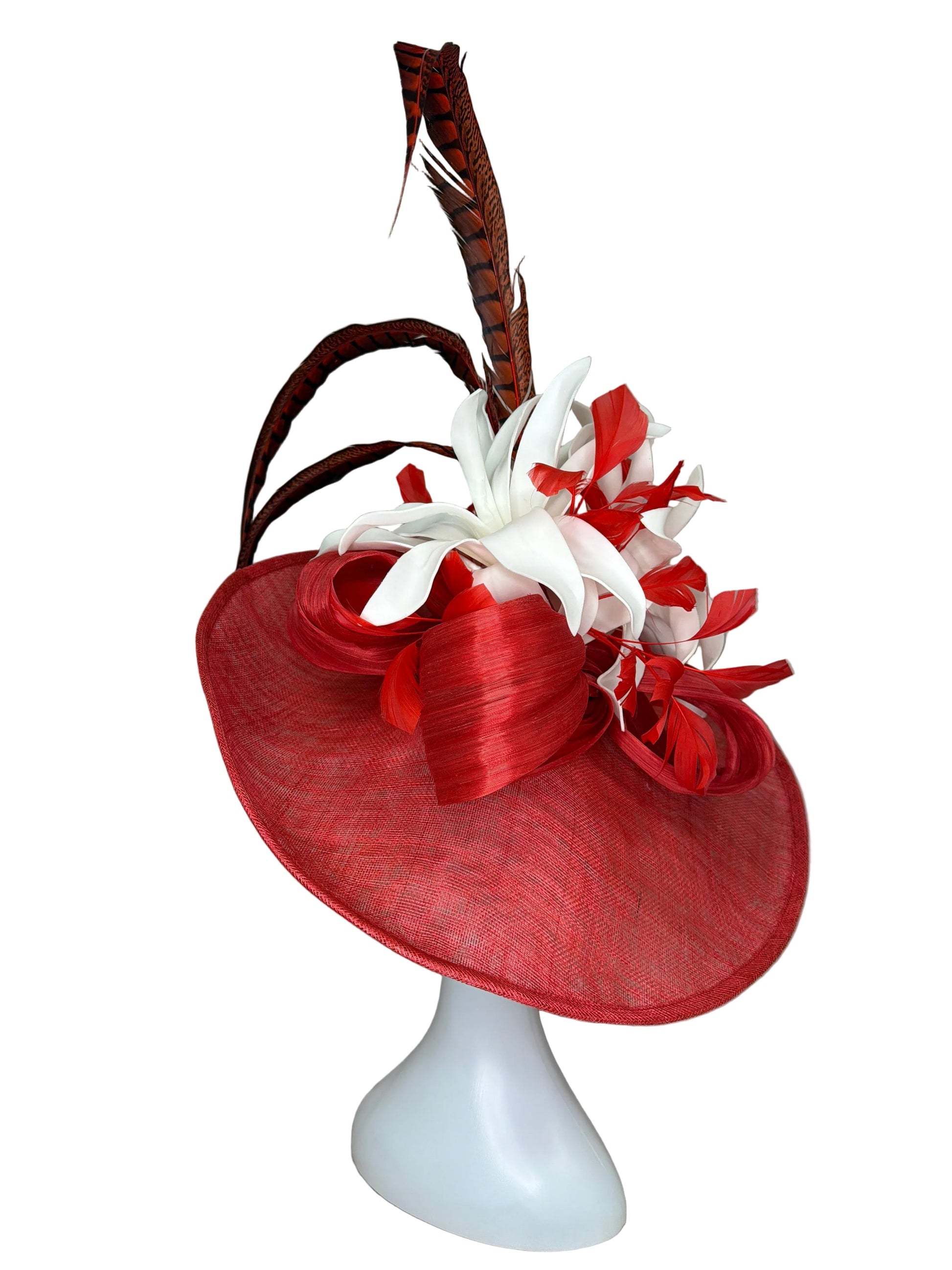 Red and white decorative headpiece on a mannequin head against a beige background