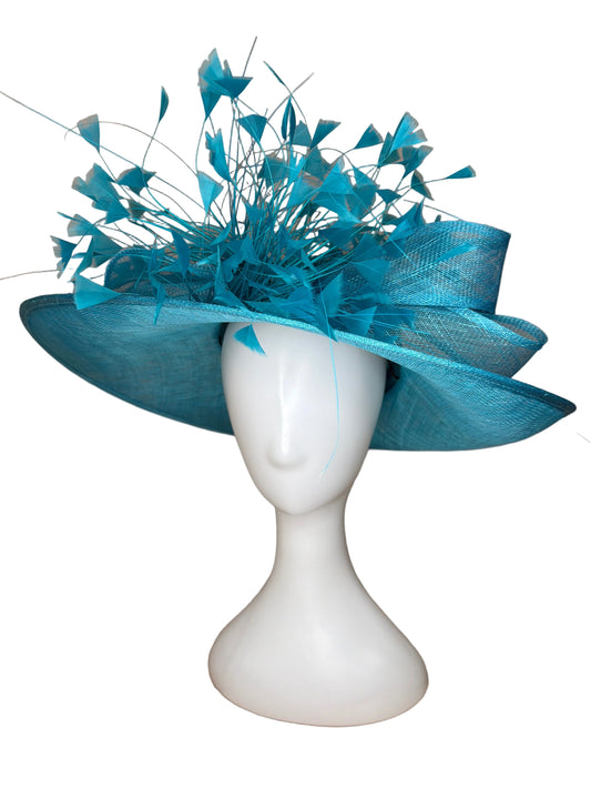 Blue decorative headpiece on a mannequin head against a beige background