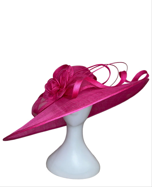 Pink decorative hat on a mannequin head against a beige background