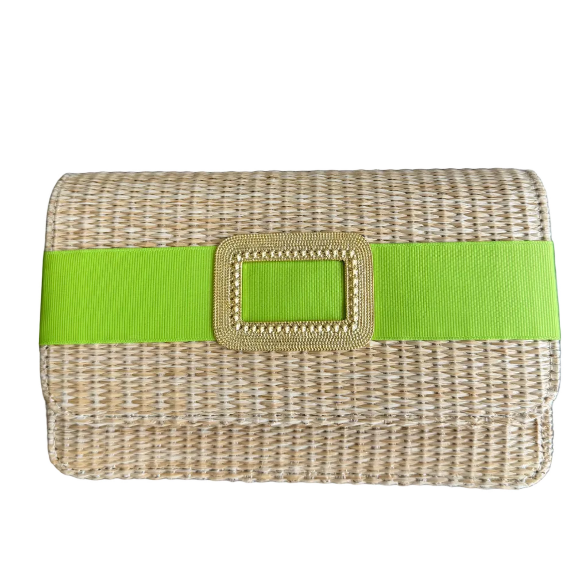 Woven clutch with a green strap on a wooden surface