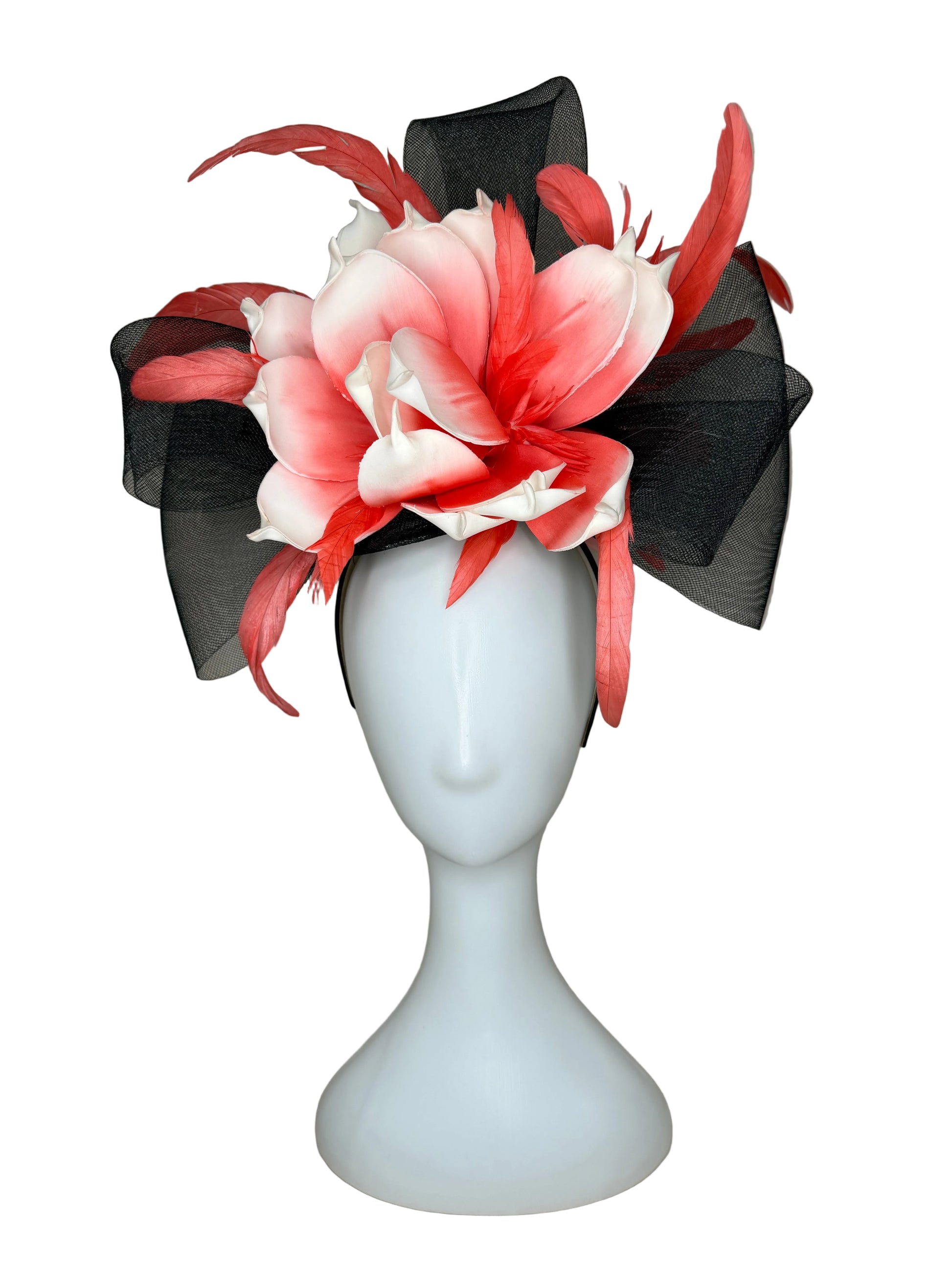 Floral headpiece with black and pink flowers on a mannequin head against a beige background