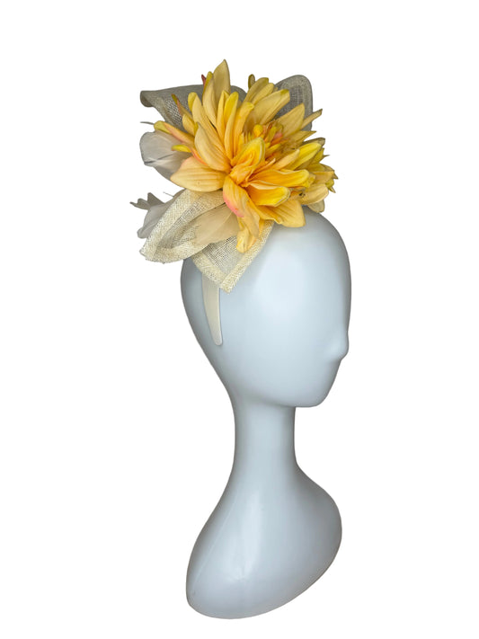 White bow tie with a yellow flower on a brown fabric background