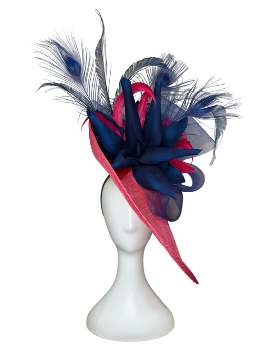 Navy and pink feathered headpiece on a mannequin head against a beige background
