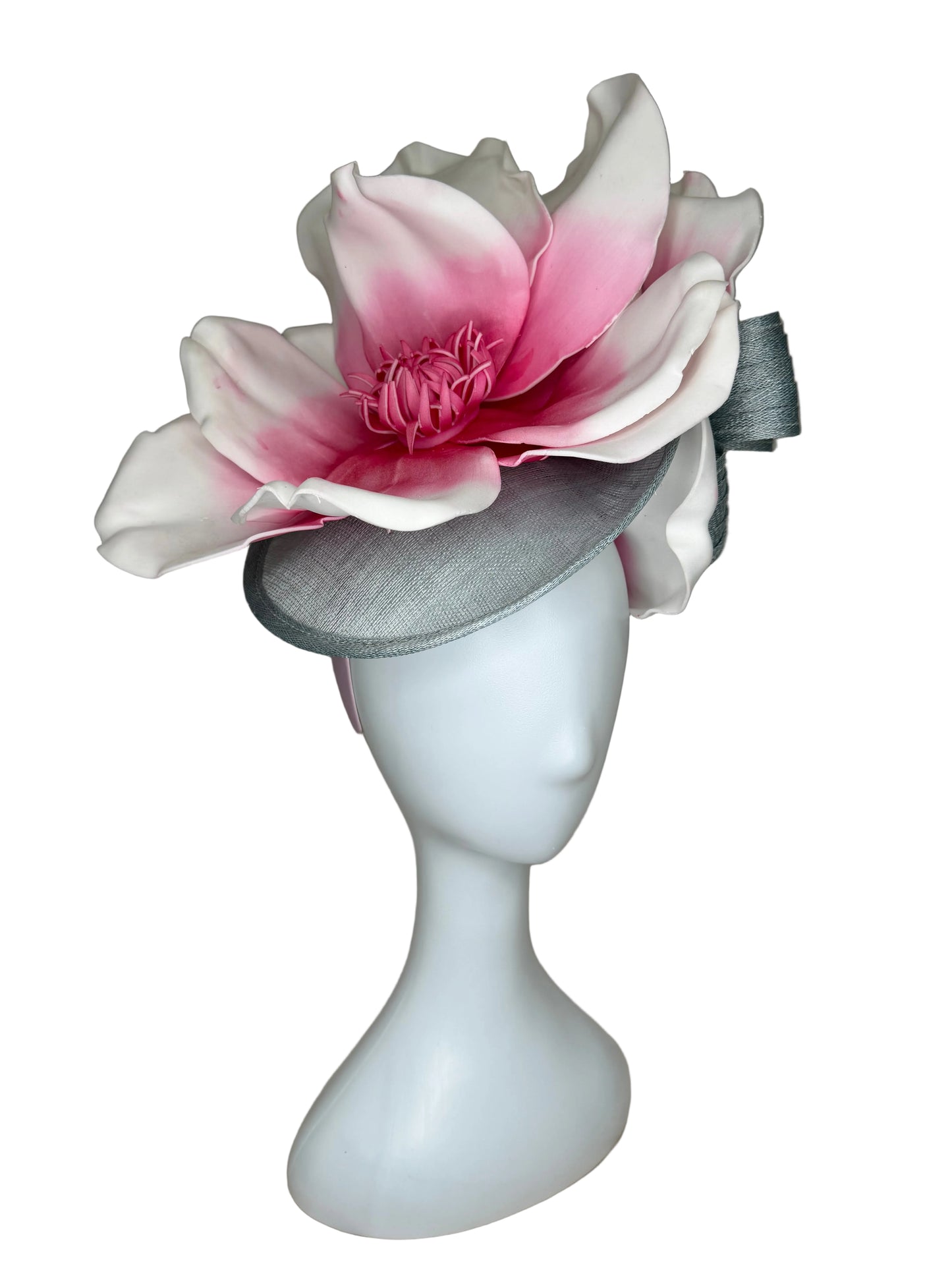 White and pink flower-shaped object on a beige fabric background