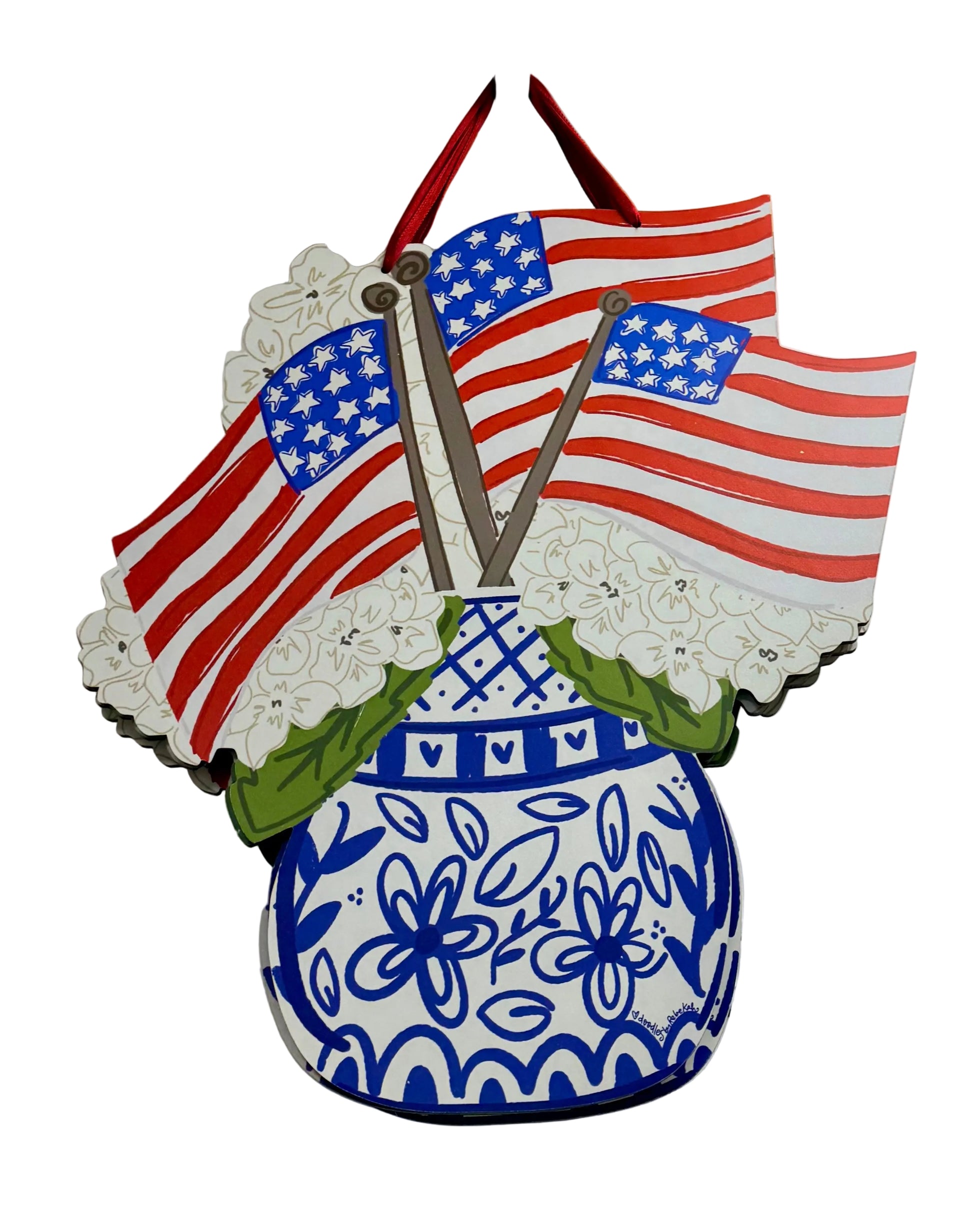Decorative wall hanging with American flags and a blue floral-patterned vase on a white background.