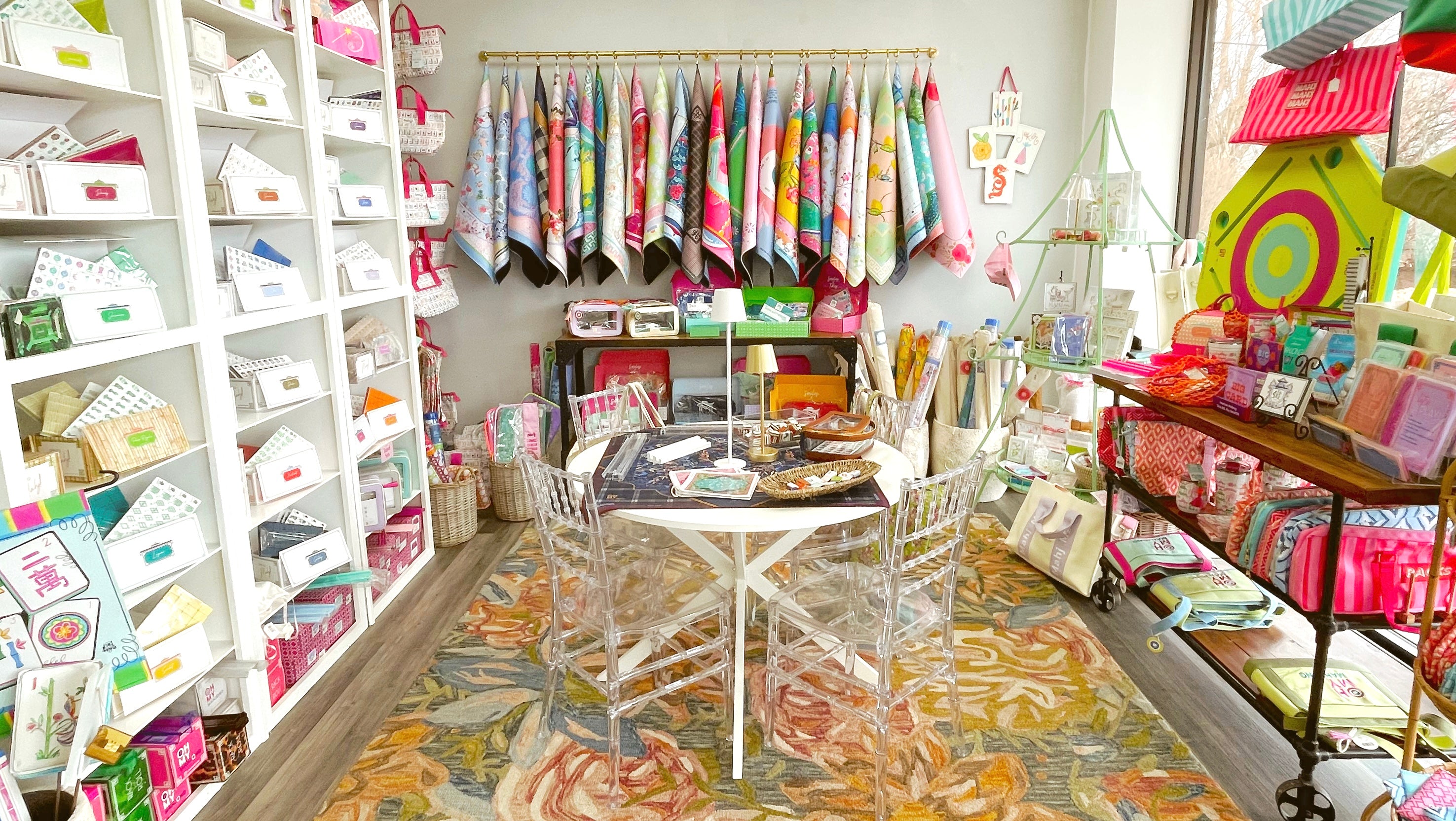 Mahjong store with shelves filled with products, a table with stationery items, and colorful decor.